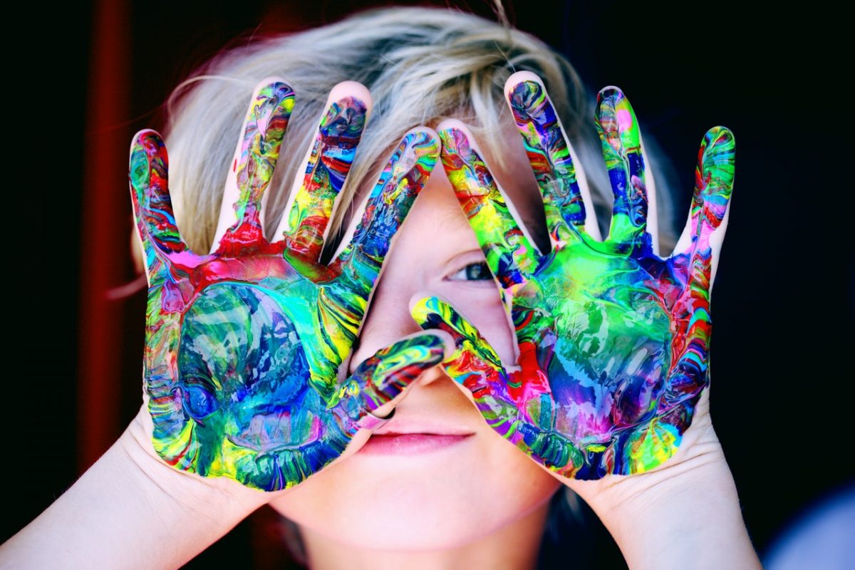 Child with mixed colour paints on their hands