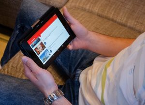 Person watching YouTube on a tablet